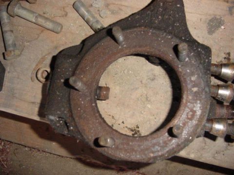 1992 Ford Bronco - Close-up of a heavily rusted metal part, likely a vehicle component, with bolts.