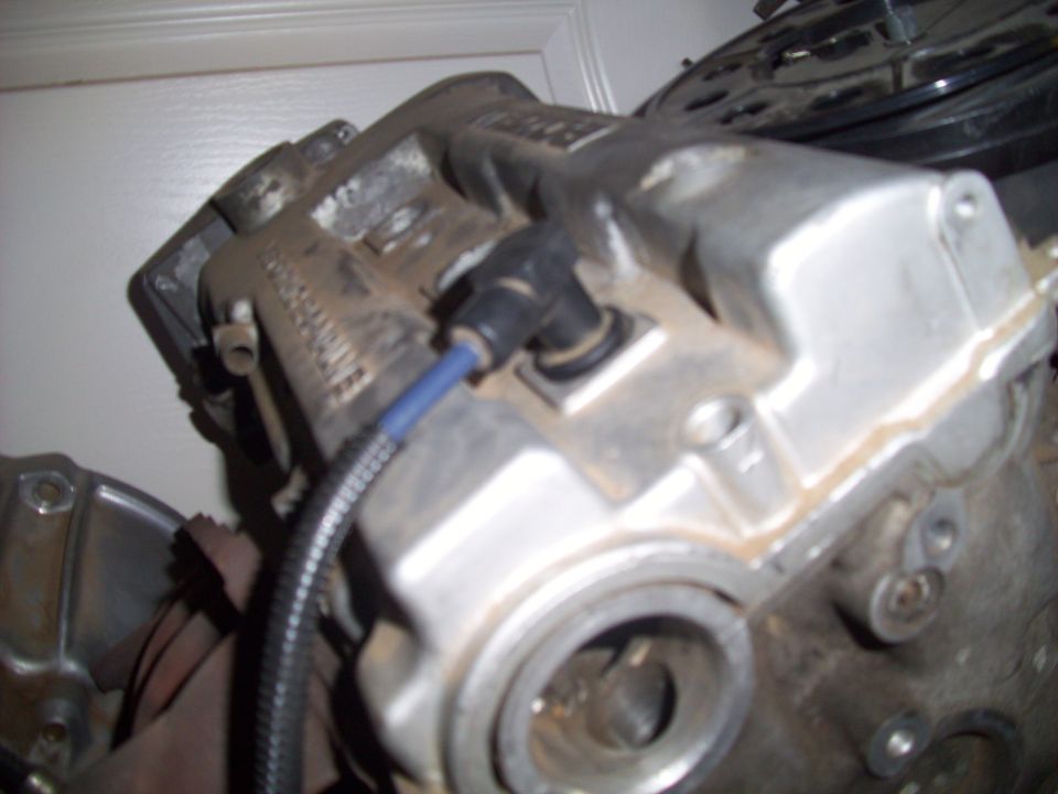 Engine part with spark plug wire attached