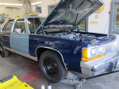 1991 Ford LTD Crown Victoria - Ford Crown Victoria in a garage with the hood up, undergoing repairs or modifications.