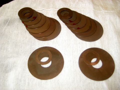 1996 Ford Bronco - Two stacks of graduated shims and two individual shims are laid out on a white cloth.