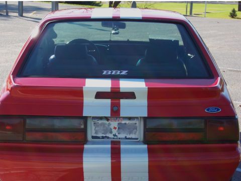 1990 Ford Mustang - This 1990 Ford Mustang features prominent white racing stripes and a Texas license plate.