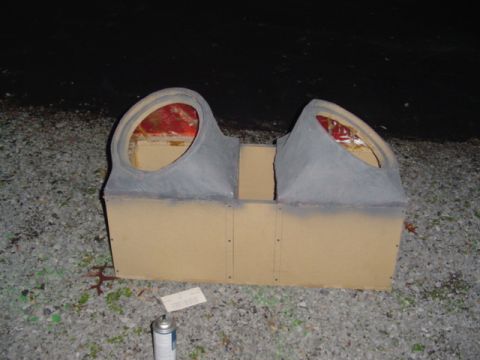 1999 Ford Taurus - Custom-built dual subwoofer enclosure with primer-gray finish and two angled openings, sitting on gravel at night beside a spray can.