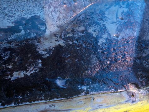 1978 Ford Bronco - This image shows significant rust and corrosion on the undercarriage of a vehicle, indicating potential structural damage.