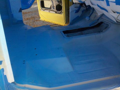 1978 Ford Bronco - Vehicle interior being prepped for painting, showing the floor and door frame.