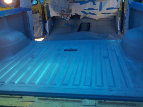 1978 Ford Bronco - The interior of a vehicle is being prepped for painting, with protective coverings on the windows and doors.