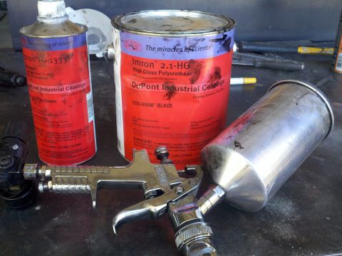 1978 Ford Bronco - A spray gun sits next to cans of Imron industrial coatings, including black polyurethane paint.