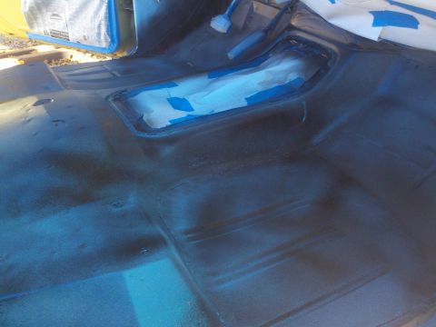 1978 Ford Bronco - Interior floor of a vehicle, possibly undergoing restoration or repair, with taped-off sections.