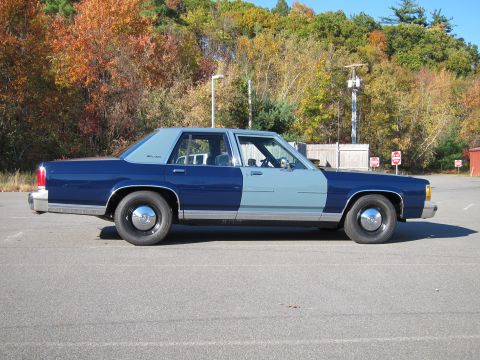 1991 Ford LTD Crown Victoria - This 1991 Ford Crown Victoria LTD sedan is seen from the side, a distinctive two-tone blue paint scheme.