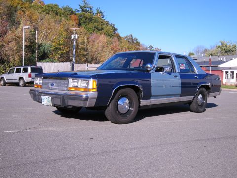 1991 Ford LTD Crown Victoria - Two-tone blue 1990 Ford Crown Victoria LTD parked in a lot, with a Jeep Cherokee nearby.