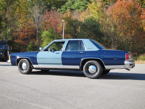 1991 Ford LTD Crown Victoria - Sedan with a two-tone paint job parked outdoors on a paved surface.