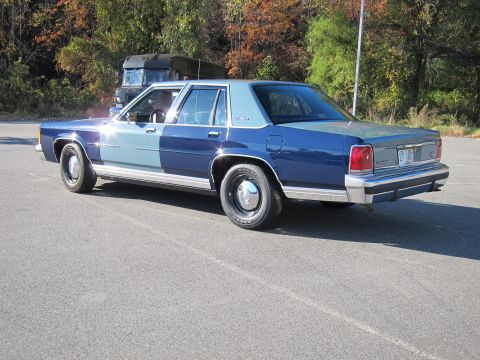 1991 Ford LTD Crown Victoria - This 1991 Ford Crown Victoria LTD sedan is seen from the rear three-quarter angle, parked outdoors.