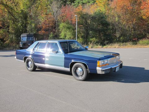1991 Ford LTD Crown Victoria - This 1991 Ford Crown Victoria LTD is seen in a parking lot with autumn trees in the background.