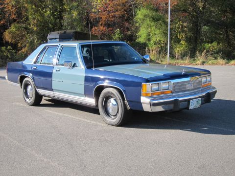 1991 Ford LTD Crown Victoria - This 1991 Ford Crown Victoria LTD features a two-tone paint scheme and a cargo box on the roof.
