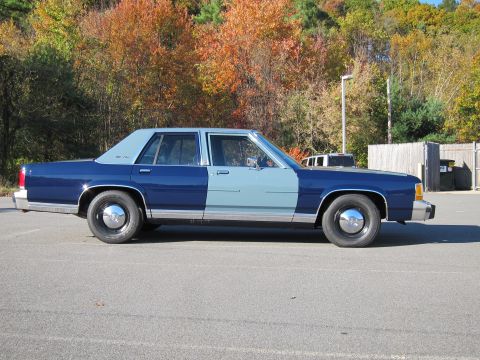 1991 Ford LTD Crown Victoria - This 1991 Ford Crown Victoria LTD sedan is seen in a side profile, a distinctive two-tone blue paint scheme.