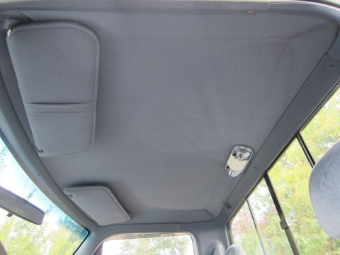 1992 Ford F-250 - Interior view of a truck's headliner, showing two sun visors and a dome light.