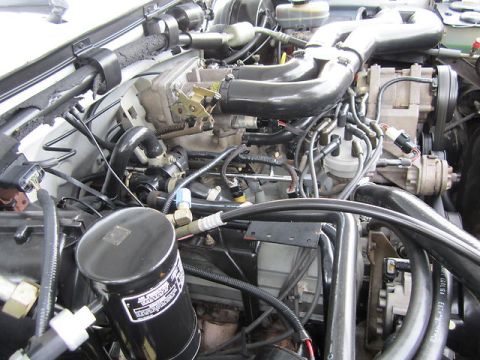 1992 Ford F-250 - Close-up view of the engine bay in a 1992 Ford F-250, highlighting various engine components.