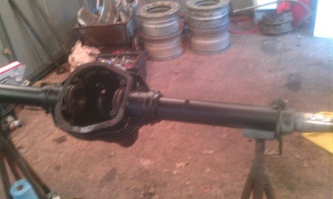 1995 Ford Bronco - Rear axle assembly, likely undergoing maintenance or repair, with parts and tools visible.