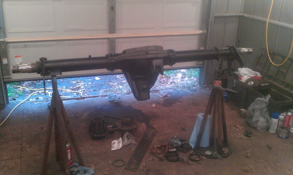 rear axle assembly on jack stands in garage