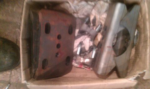 1995 Ford Bronco - These automotive parts are stored in a cardboard box, awaiting installation or further inspection.