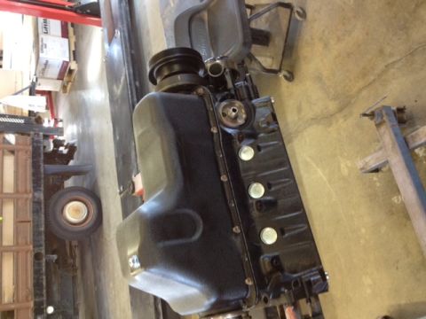 1994 Ford Bronco - Engine block and oil pan assembly, likely for a Ford vehicle, in a workshop setting.
