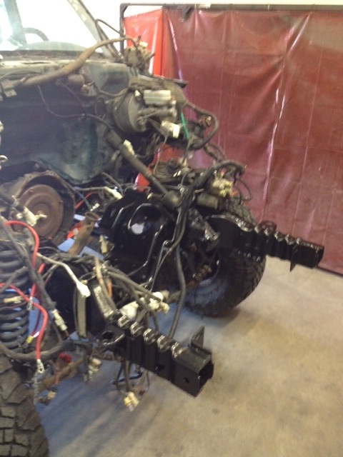 1994 Ford Bronco - Vehicle frame and engine components are visible during a rebuild process.