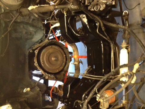 1994 Ford Bronco - The image shows the transmission and engine bay of a vehicle, with various hoses and mechanical parts visible.
