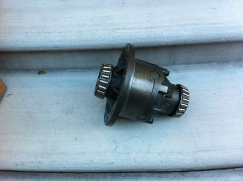 1995 Ford Bronco - Differential carrier with bearings shown on a light-colored surface.