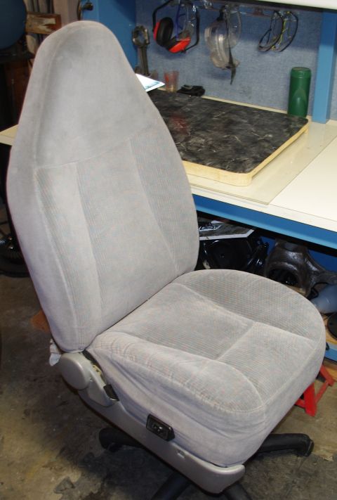 Gray fabric car seat with visible adjustment levers on the side