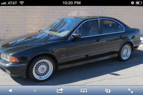 1999 BMW 5 Series - Black 1999 BMW 5 Series sedan parked outdoors.