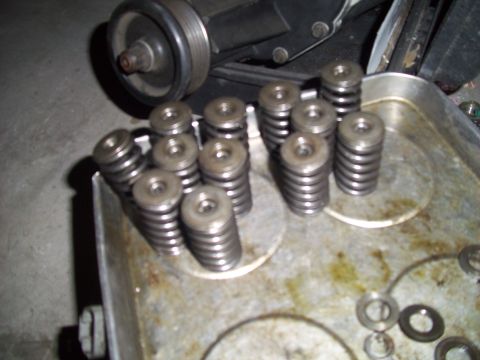 1995 Ford Probe - Valve springs are shown in a metal tray, with a pulley visible above.