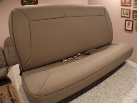 1992 Ford F-250 - A tan leather bench seat with seatbelts is shown from a side angle.
