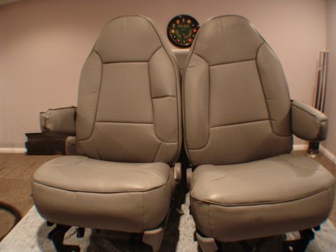 1992 Ford F-250 - Two tan front bucket seats are shown, likely for a truck or SUV, with armrests and visible stitching details.
