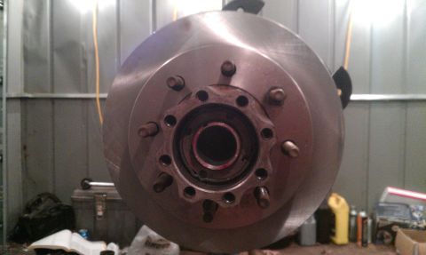 1995 Ford Bronco - Close-up of a vehicle's brake rotor and hub assembly, showing the lug nut pattern and center bearing area.