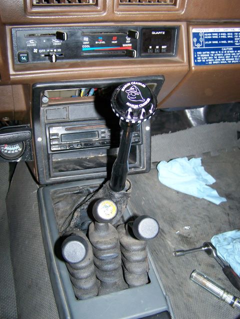 1988 Suzuki Samurai - The interior of a vehicle shows a "Marlin Crawler" shift knob and several gear shifters on the center console.