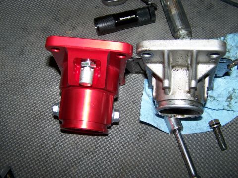1988 Suzuki Samurai - Comparison of a red aftermarket part next to a used silver OEM part, likely for an engine or transmission.