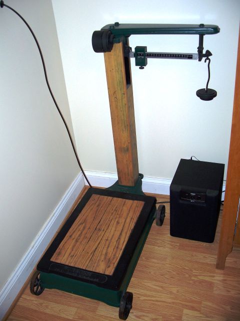 1971 Ford Ranchero - A vintage scale with a wooden platform and a black speaker sits on a hardwood floor.