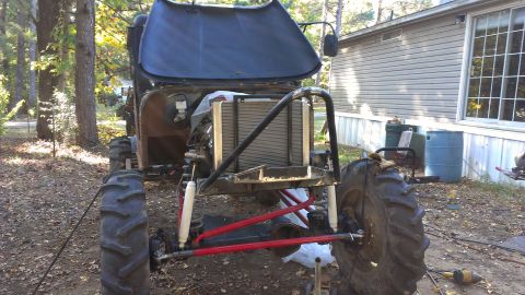 1978 Ford Bronco - This heavily modified off-road vehicle is undergoing work outdoors, with its hood open to reveal the engine compartment.