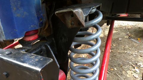 1978 Ford Bronco - This image shows the suspension system of a vehicle, focusing on the coil spring and shock absorber.