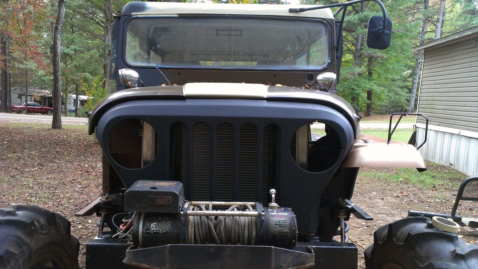 Jeep M38A1 front view, dark brown and tan, with winch and large tires