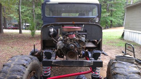 1978 Ford Bronco - Front view of a 1978 Jeep CJ-5's engine bay, showing the V8 engine and off-road modifications.