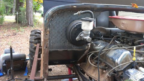 1978 Ford Bronco - This photo shows the engine bay and fender area of a Jeep CJ-series vehicle, with a large tire on the left.