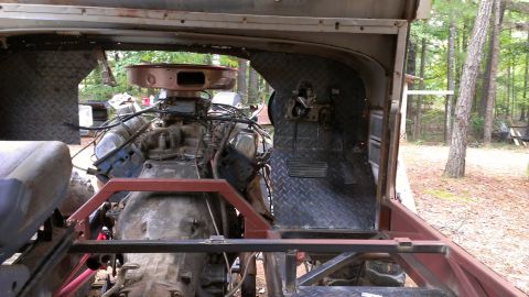 1978 Ford Bronco - The interior of a custom vehicle shows a large engine and diamond plate flooring.