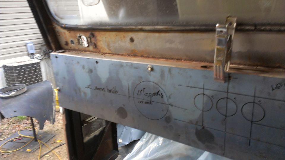 Metal panel with handwritten notes and circles drawn on it, possibly for a custom build
