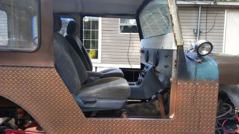 1978 Ford Bronco - The interior of a custom-built off-road vehicle, aftermarket seats and diamond plate accents.