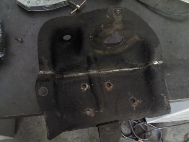 Welded metal bracket with multiple holes and signs of repair