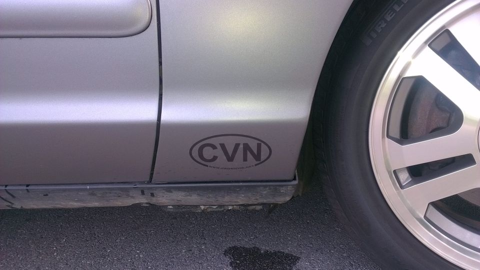 Silver sedan rocker panel with oval CVN sticker and Pirelli-tire alloy wheel