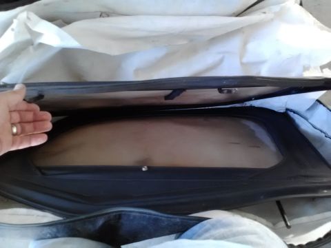 1978 Ford Bronco - Interior view of a car cover with a window, a hand is visible reaching inside.