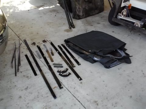 1978 Ford Bronco - Various car parts are spread out on the ground, possibly for repair or storage.