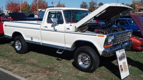 2007 Ford Mustang - This white 1979 Ford F-150 pickup truck is displayed with its hood open, revealing the engine bay.