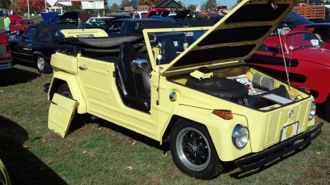 2007 Ford Mustang - A yellow Volkswagen Thing convertible is displayed with its hood open and doors removed at an outdoor car show.
